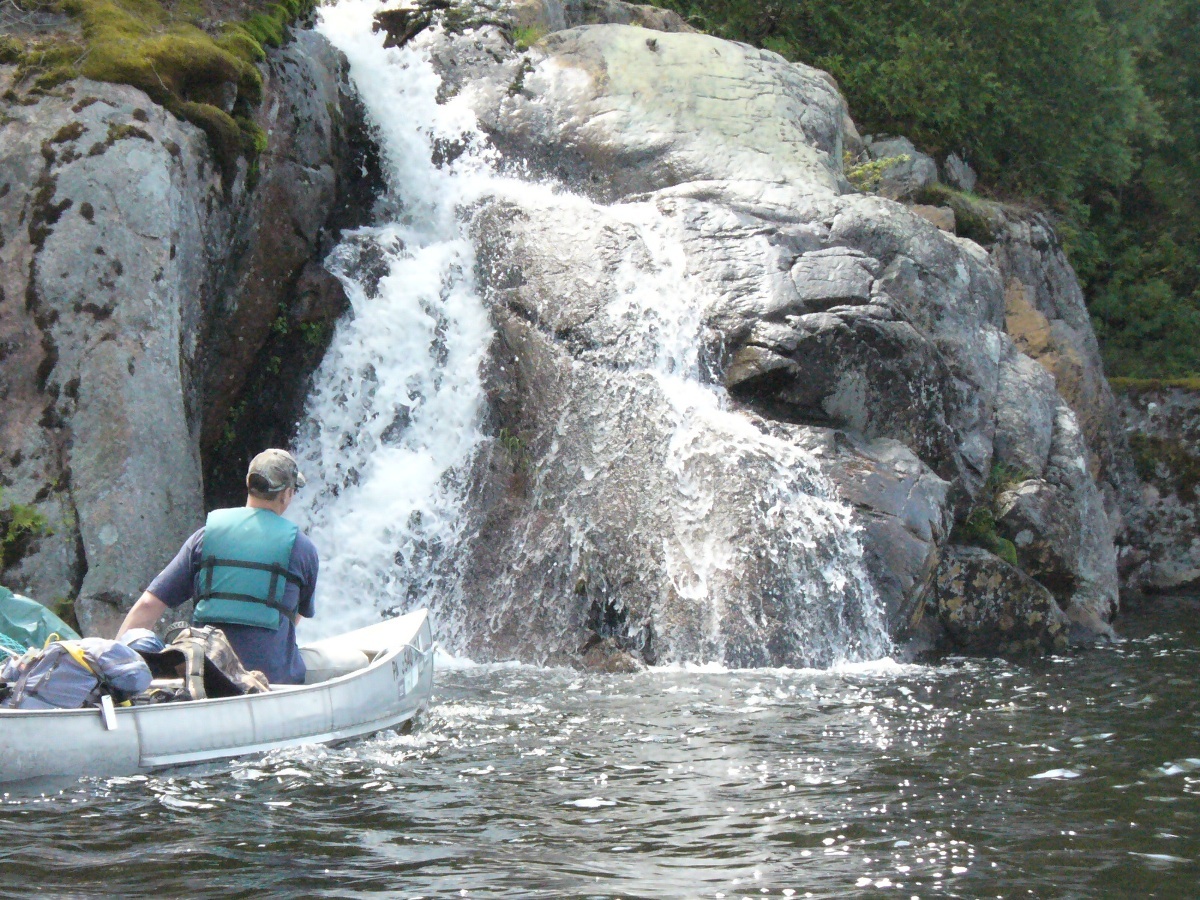 paddling past waterfall